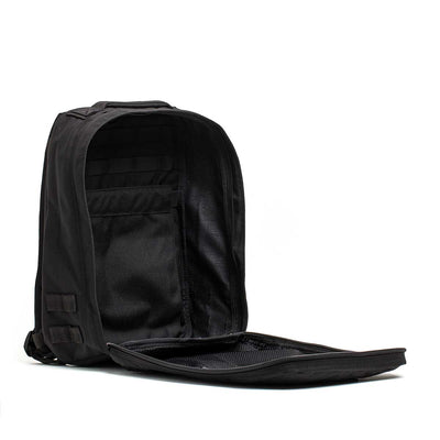 The Radio Ruck USA Throwback backpack, shown with its main compartment open, reveals interior pockets, a zippered mesh section, and a bombproof laptop compartment inspired by Special Forces durability.