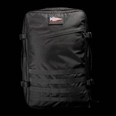 Black GORUCK tactical rucksack with American flag patch, MOLLE webbing, and durable fabric