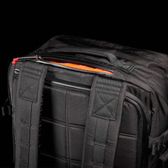 GORUCK Robic 45L black rucksack with padded back and straps, showing orange interior compartment