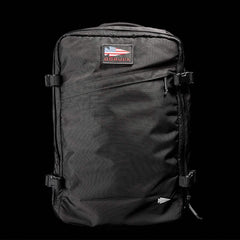 Black GORUCK tactical backpack with American flag patch on front isolated on black background