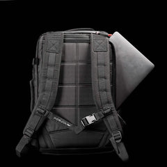 GORUCK black tactical backpack with padded shoulder straps and a laptop partially inserted in back compartment