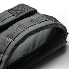 Close-up of a black padded strap with stitching details from the RPC 3.0 + 10lb Ruck Sandplate, shown on a white background—perfect for weighted training.