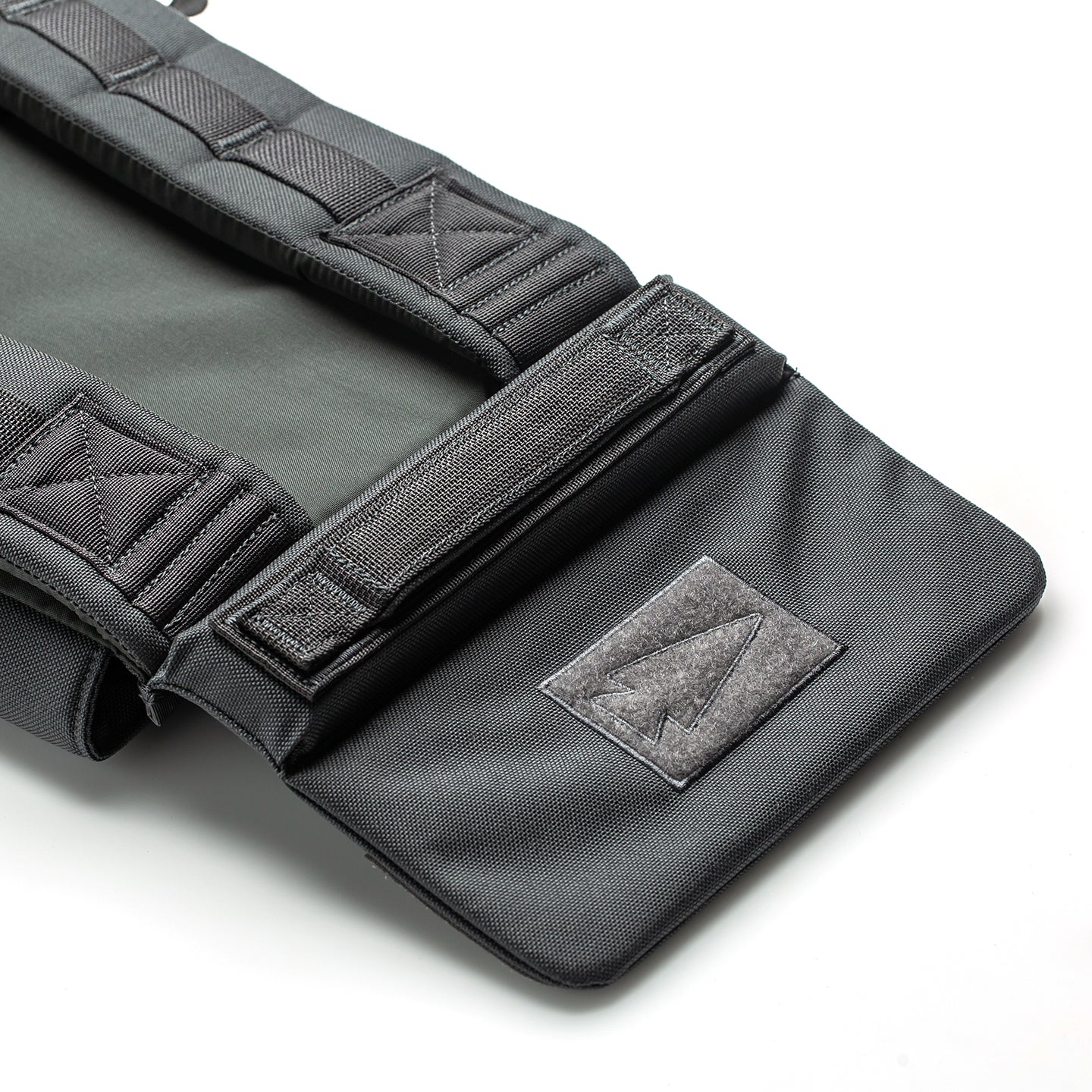 Close-up of a black and gray fabric strap with reinforced stitching and an arrow patch, designed for use with the RPC 3.0 + 10lb Ruck Sandplate for weighted training.