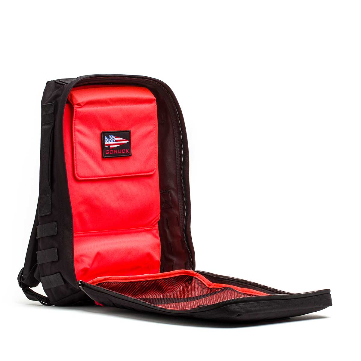 The 20L Rucker 4.0—GORUCK x Arnold's Pump Club features a fully unzipped front, revealing bright red interior pockets and mesh sections—perfect for rucking or carrying your Arnold’s Pump Club essentials in style.