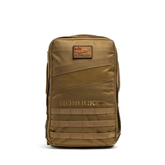 The tan Rucker 4.0 features a front patch, zipper pocket, and horizontal webbing on the lower section—perfect as a weighted rucksack or for fitness training.