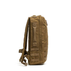 Side view of the tan Rucker 4.0 backpack, featuring MOLLE webbing and padded shoulder straps—perfect as a fitness training bag for outdoor adventures.