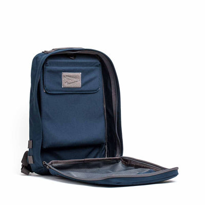 The Rucker 4.0, in navy blue, is open to reveal its spacious interior and a mesh pocket located inside the front flap.