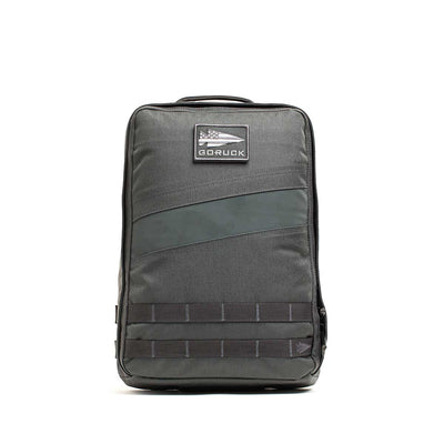 A gray Rucker 4.0 rucksack with a front patch and black horizontal bottom straps, ideal for rucking adventures.