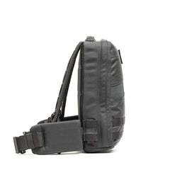 Side view of the dark gray Rucker 4.0 sling backpack featuring an adjustable strap, multiple compartments, and space for Ruck Plates—ideal for rucking or everyday carry.