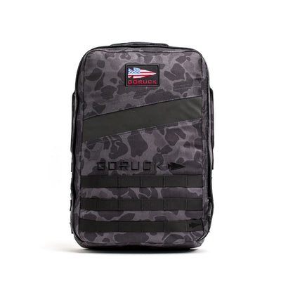 The Rucker 4.0 is a black camo rucksack with an American flag patch and "GORUCK" branding on the front—ideal for rucking adventures.
