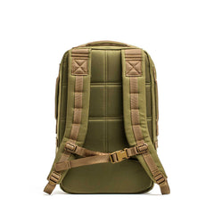 The Rucker 4.0, shown from the back in olive green, features padded straps and a sternum strap, and is designed to hold ruck plates for a weighted training pack experience.
