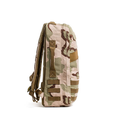 Side view of the Rucker 4.0 in tan and brown camouflage, featuring padded shoulder straps and MOLLE webbing—ideal for rucking adventures.