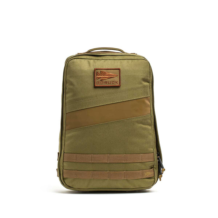The Rucker 4.0 is an olive green backpack with a top handle, diagonal accent, GORUCK patch, and front MOLLE webbing—ideal for carrying ruck plates during weighted training sessions.