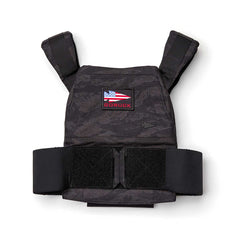 The Rucking Weight Vest features a black tactical design with an American flag and "GORUCK" patch on the front. It's perfect for rucking sessions and is compatible with Curved Ruck Plates for increased resistance.