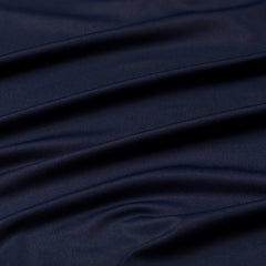 Close-up of smooth, dark navy EnduraKnit fabric on the Men's Long Sleeve Rucking Polo, showcasing soft horizontal folds and a subtle sheen.