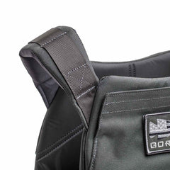 Close-up of the Rucking Weight Vest's black shoulder strap, showcasing detailed stitching and a front patch—perfect for rucking with Curved Ruck Plates.
