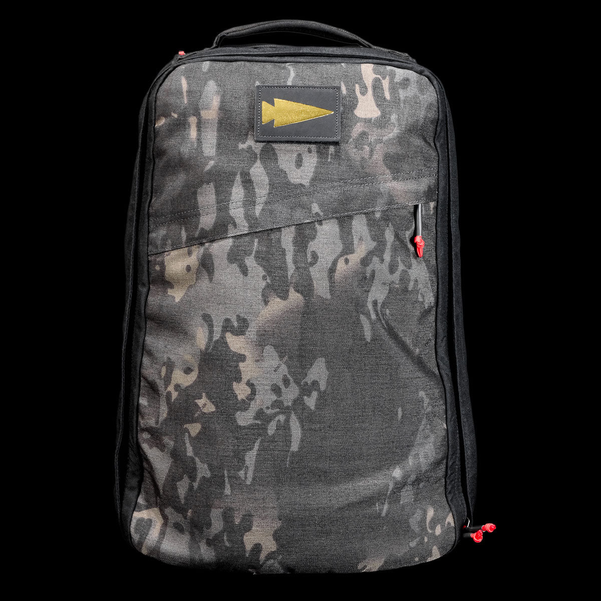 The GR1 Shooter 26L - Built by Scars is a camo-patterned backpack crafted from rugged CORDURA®, with a yellow arrow patch and red zipper pulls, shown on a black background.