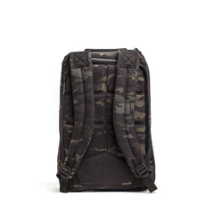 The GR1 USA Slick - Ballistic Nylon Cordura backpack in black and gray camo is shown from the back, highlighting its padded shoulder straps, back panel, and bombproof laptop compartment.