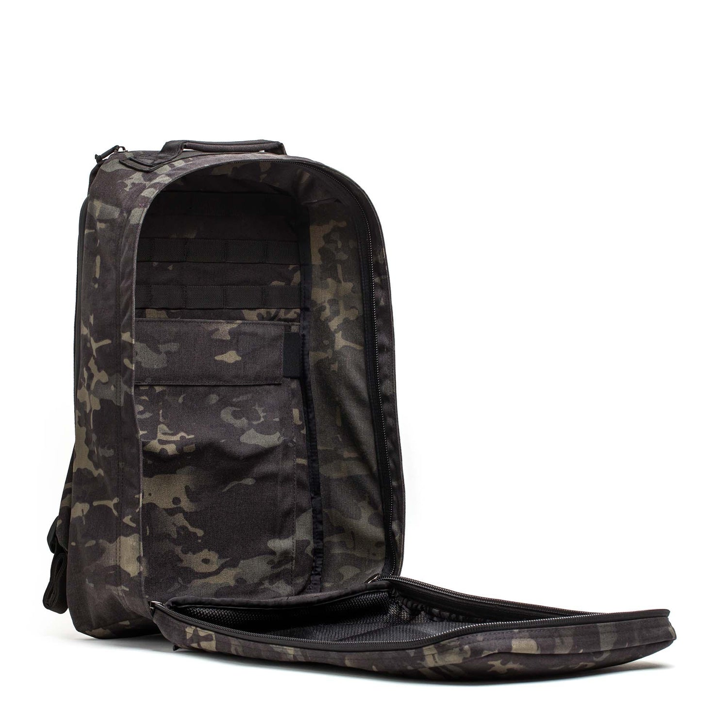A GR1 USA Slick - Ballistic Nylon Cordura backpack stands upright with its front fully unzipped, showing interior pockets and a bombproof laptop compartment.