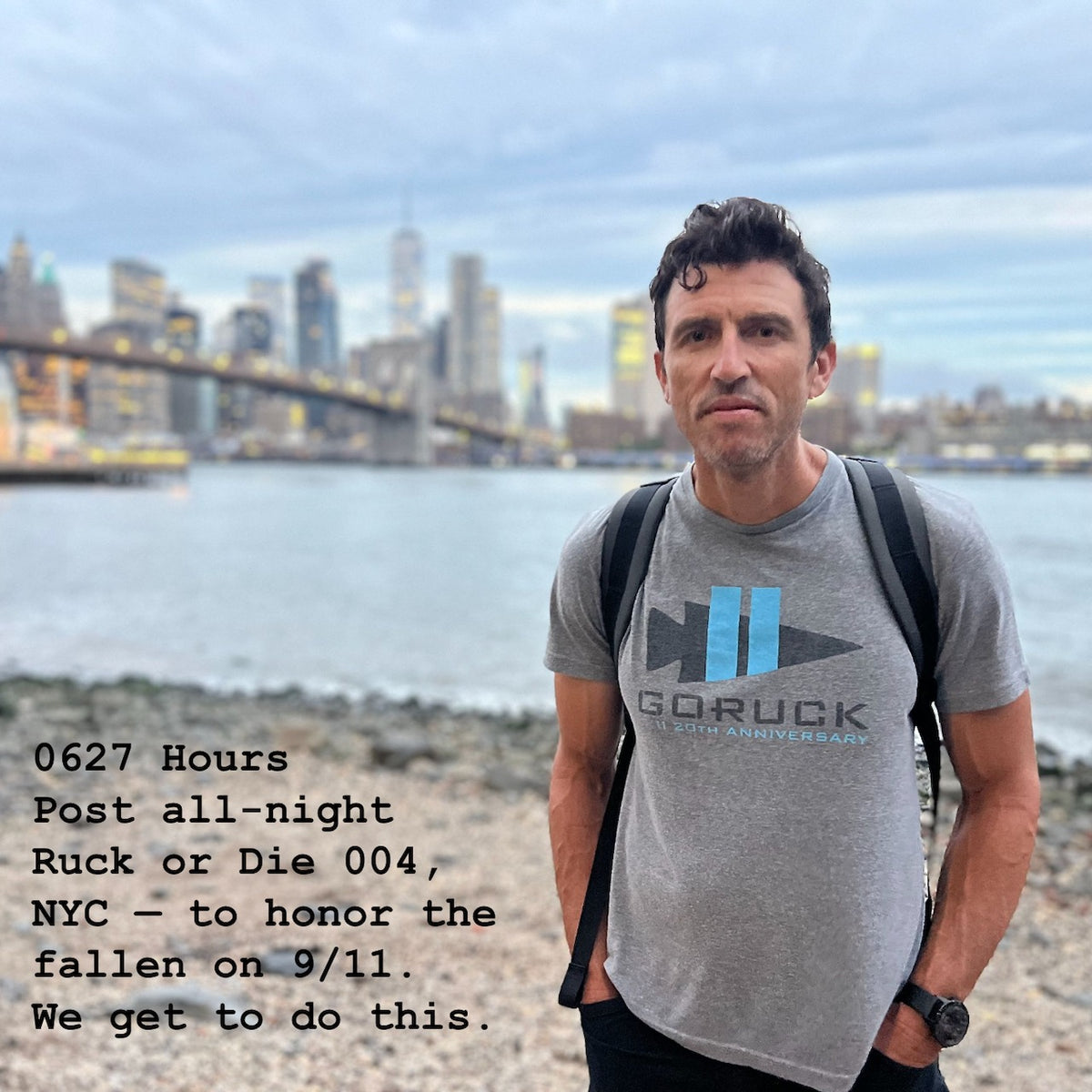 A man stands by the East River with the NYC skyline behind him, wearing a Basic Rucker shirt; event text overlay pays tribute to 9/11 and celebrates the rucking community’s spirit.