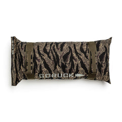 The Simple Training Sandbags feature a camouflage design, two olive green straps, and the GORUCK logo on the front—ideal for effective sandbag training in your home gym.