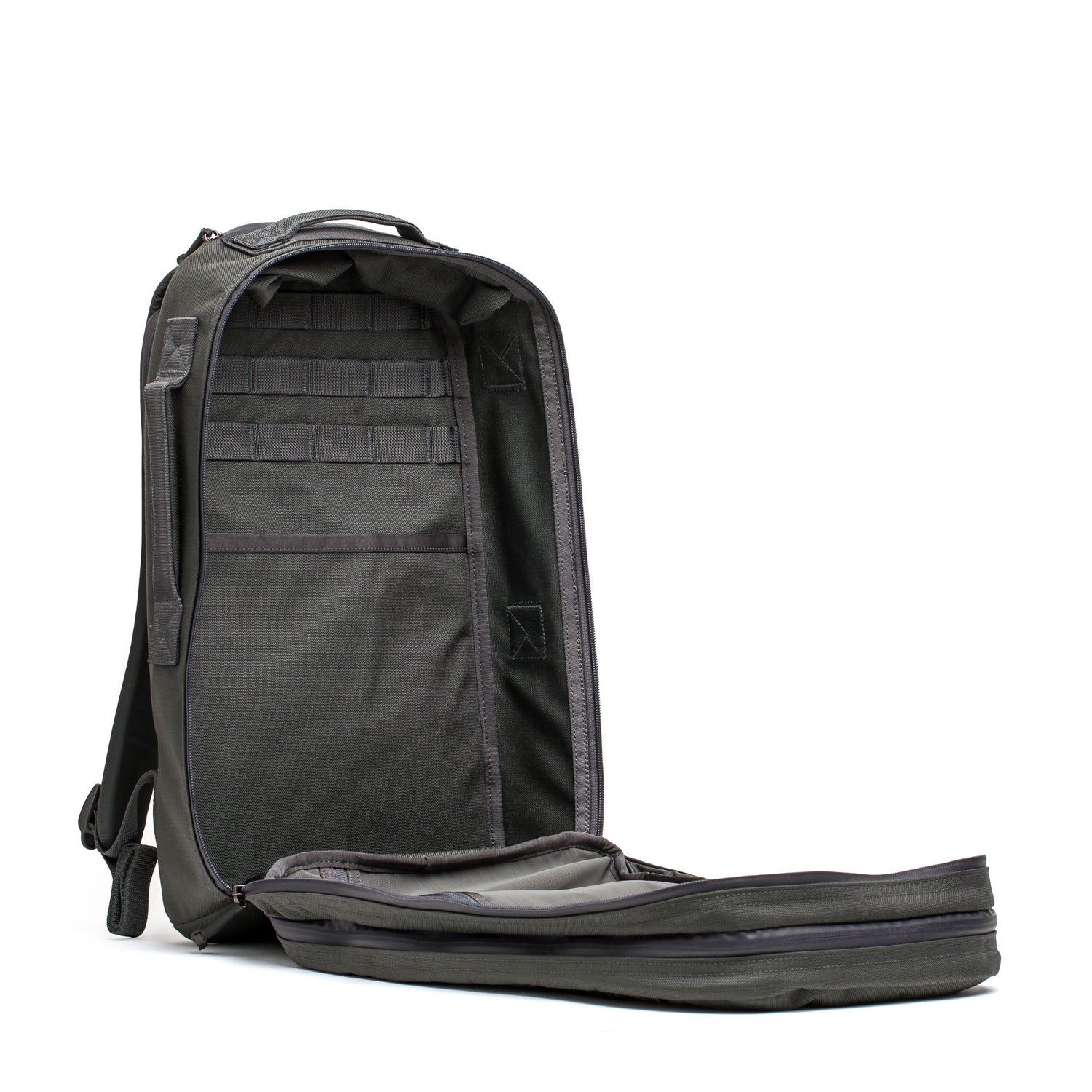 The Skate Ruck, an all-black EDC bag, is open to show its empty, roomy interior with multiple pockets and a bombproof laptop compartment.
