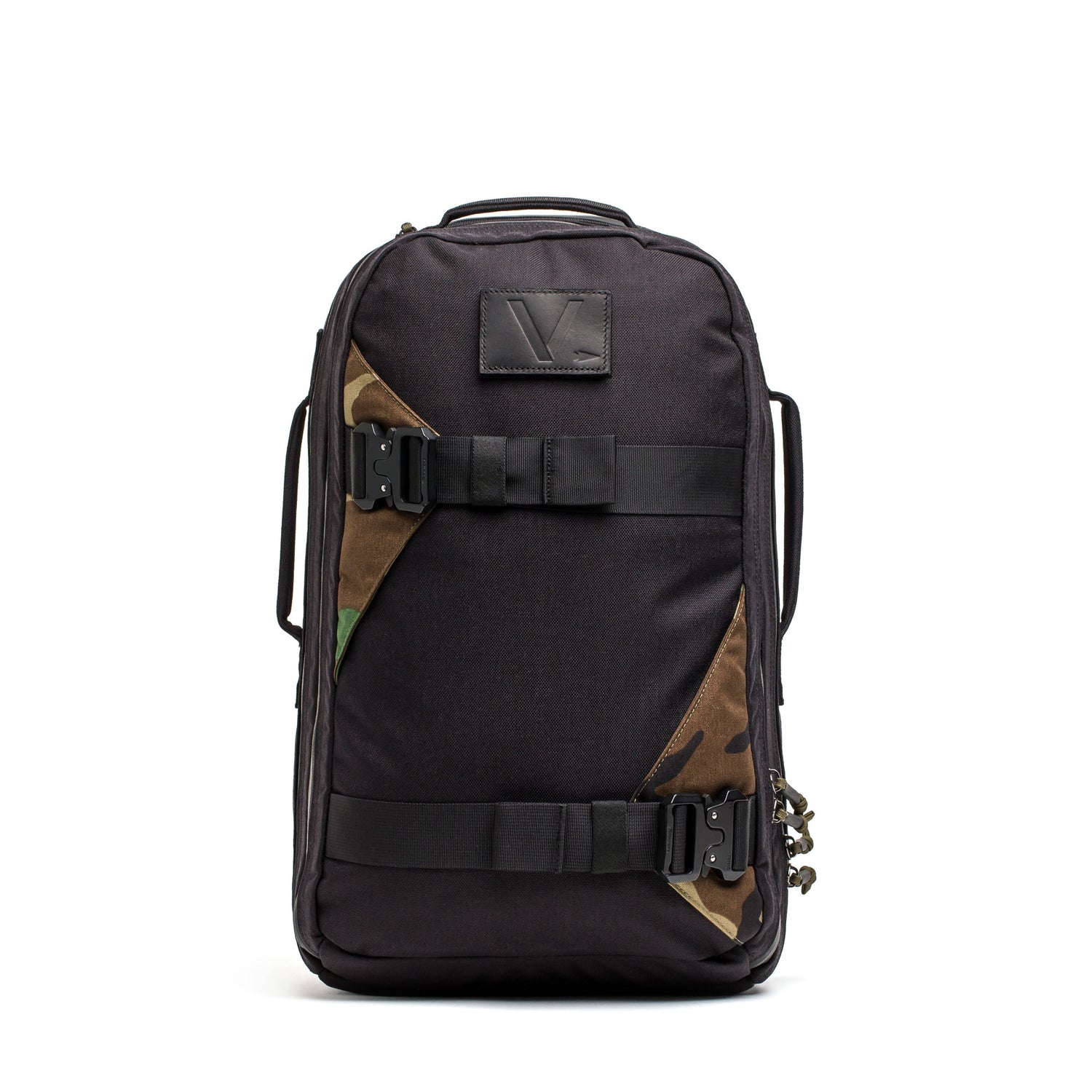 The Skate Ruck is a black EDC bag featuring side handles, buckle straps, a bombproof laptop compartment, and camouflage accents on the front.