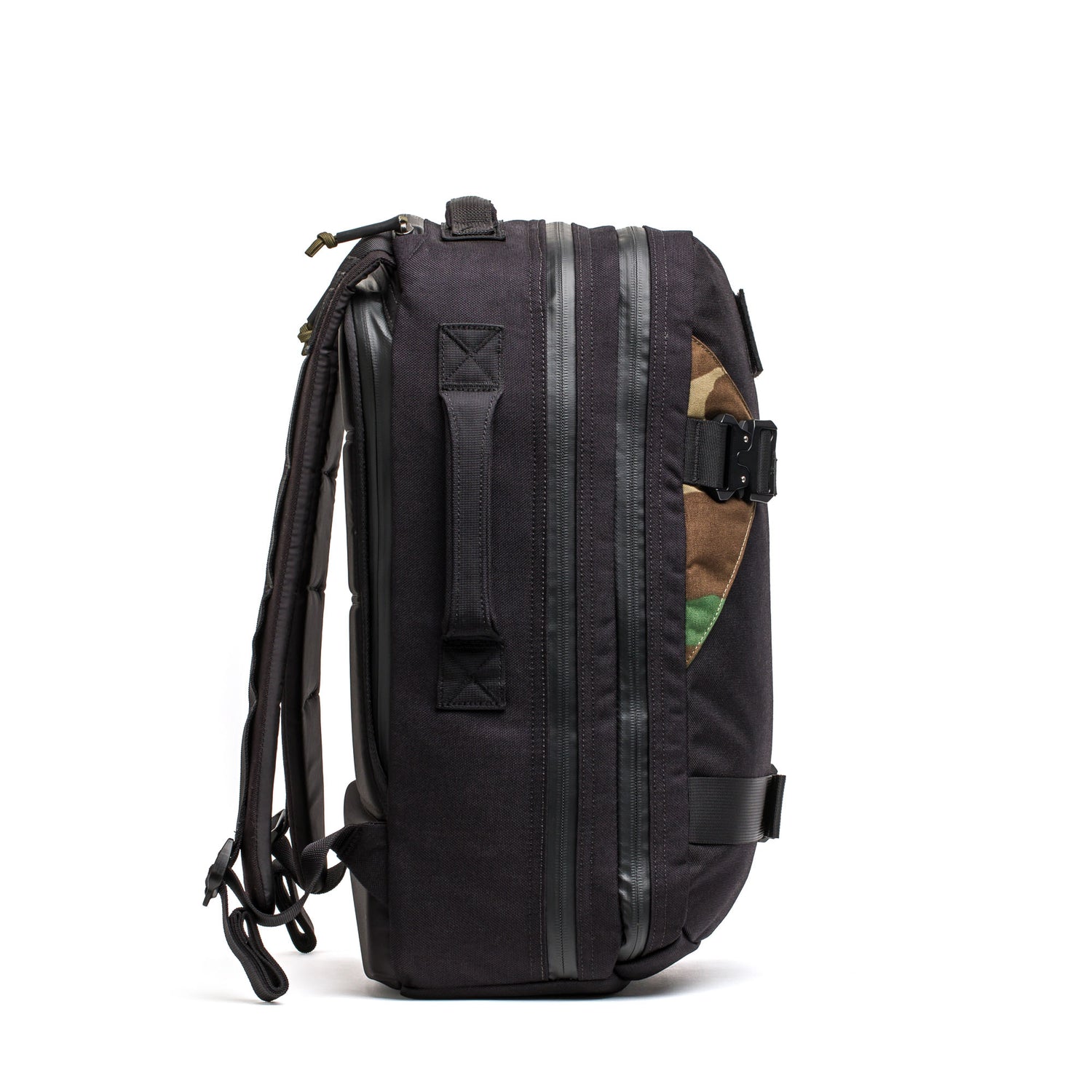 Side view of the Skate Ruck backpack, showcasing zipper accents, a rugged laptop compartment, and a hint of camouflage fabric.