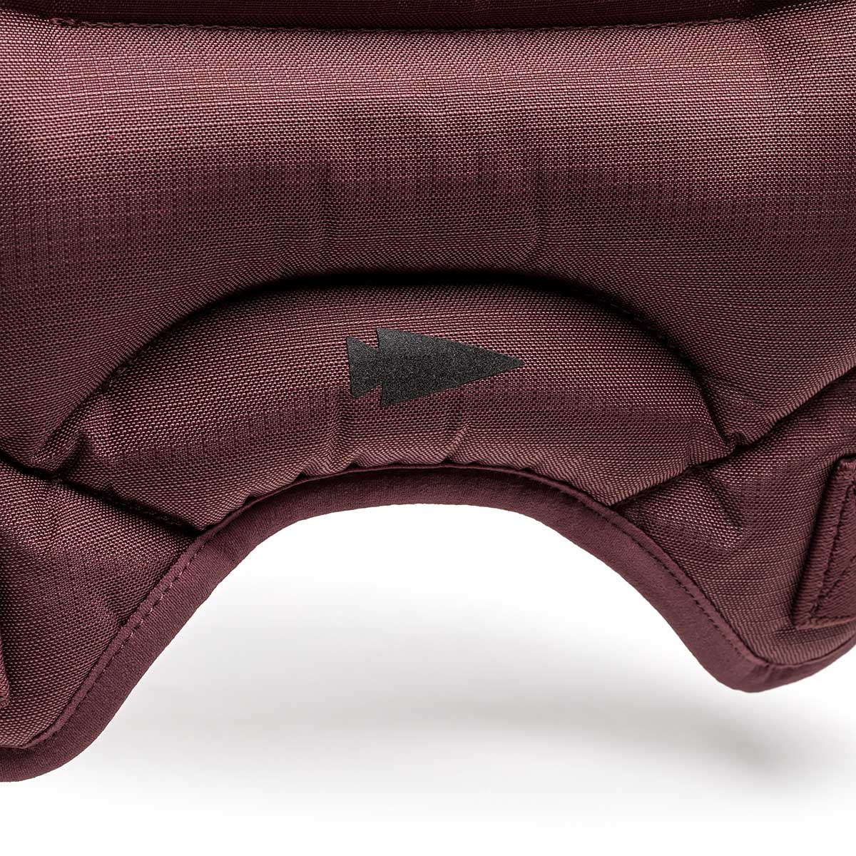 Close-up of maroon padded fabric with a black upward arrow symbol, featured on the Spy Ruck | Women's Weighted Vest.