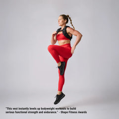 Woman in red workout gear performing high knee exercise wearing black GORUCK training vest.