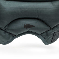 Close-up of dark green padded fabric from the Spy Ruck | Women's Weighted Vest, featuring a black arrow symbol.