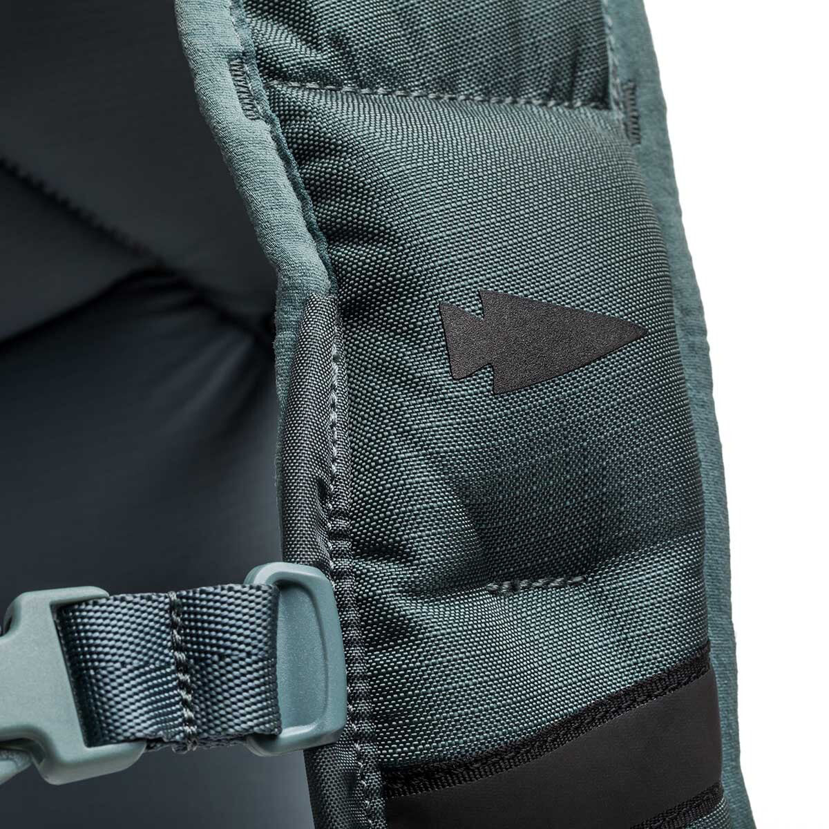 Close-up of a padded Spy Ruck backpack strap with a black arrow symbol and blue buckle, showcasing details ideal for women’s fitness gear or weighted vest fans.