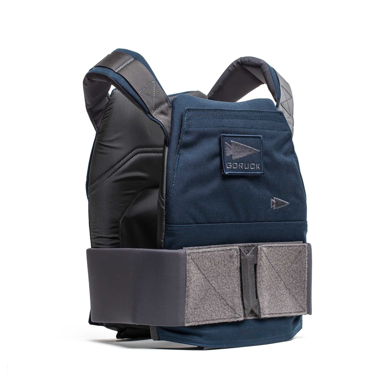 The Rucking Weight Vest is a dark blue training vest with adjustable gray straps, a front Velcro closure, and is designed to securely hold curved ruck plates, shown upright.