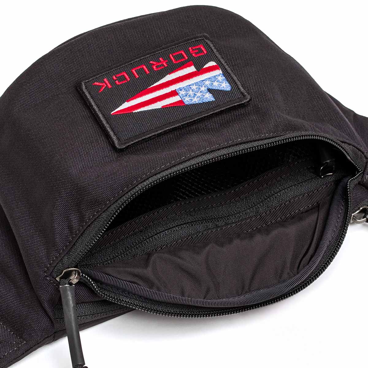 The Tactical FP1 is a black zippered pouch with an American flag patch labeled 