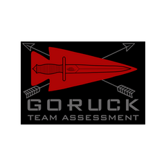 Logo featuring a red spearhead, knife, and two crossed arrows above the text "GORUCK Team Assessment," symbolizing the ultimate team endurance event—Team Assessment—led by experienced GORUCK Cadre.