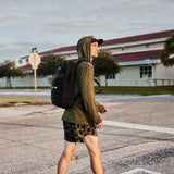 Man rucking in GORUCK Tough Mesh Hoodie and backpack outdoors on city street