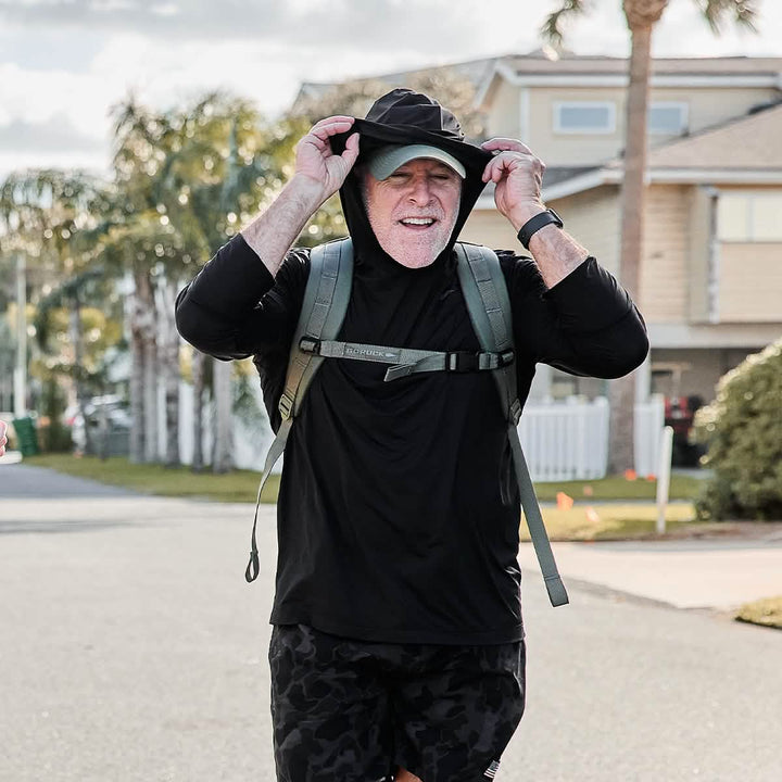 Man smiling while rucking in Men's Sun Hoodie - ToughMesh in Black