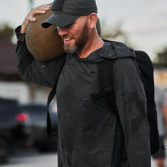 Man smiling while working out in Men's Sun Hoodie - ToughMesh Charcoal