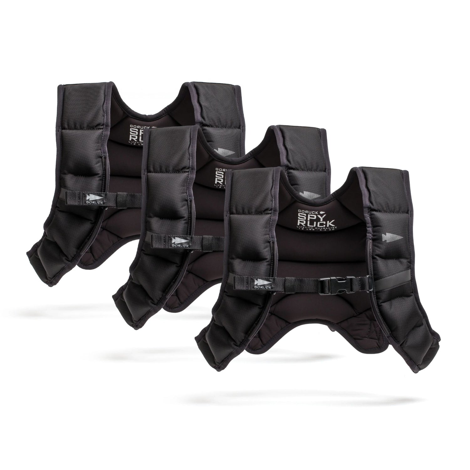 Three black Spy Ruck Bundle weighted vests with adjustable straps, including a women’s Weighted Vest, are arranged in a row on a white background.