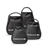 Four black GORUCK Kettlebell Bundle sandbags of different sizes with handles, grouped on a white background—each built tough like portable sand kettlebells and backed by a lifetime guarantee.