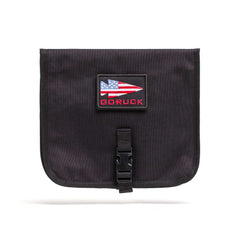 The Wire Dopp is a black pouch with an American flag patch and "GORUCK" text, front buckle closure—ideal as a travel organizer or cable pouch for your EDC essentials.