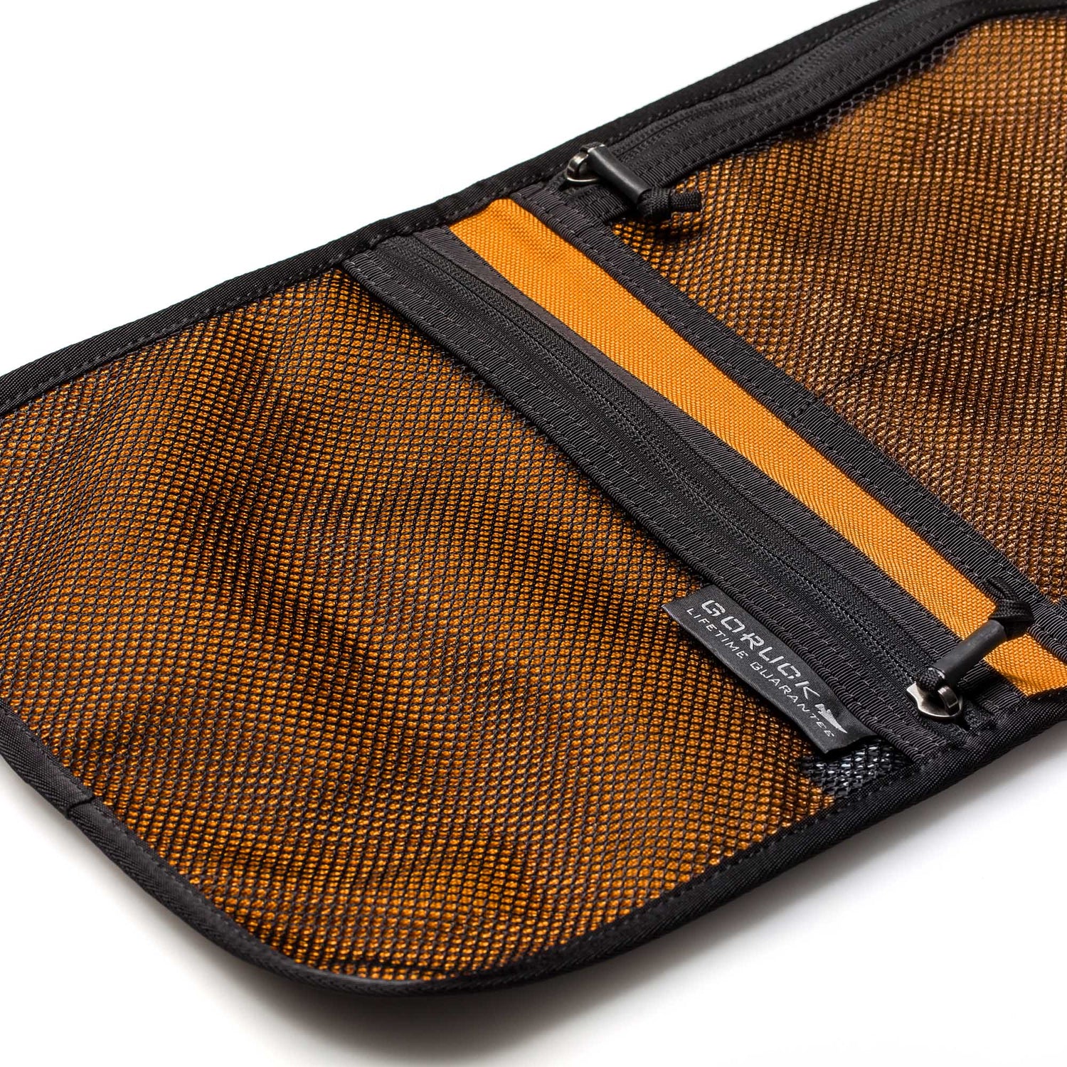 The Wire Dopp is an open orange and black cable pouch with a mesh inner pocket, visible zipper, and GORUCK tag—ideal for organizing EDC essentials or as a compact travel organizer.