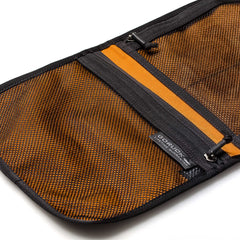 The Wire Dopp is an open orange and black cable pouch with a mesh inner pocket, visible zipper, and GORUCK tag—ideal for organizing EDC essentials or as a compact travel organizer.