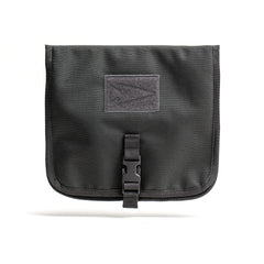 The Wire Dopp is a black fabric travel organizer pouch featuring a flap, buckle closure, and front rectangular patch—ideal for keeping your EDC essentials secure.