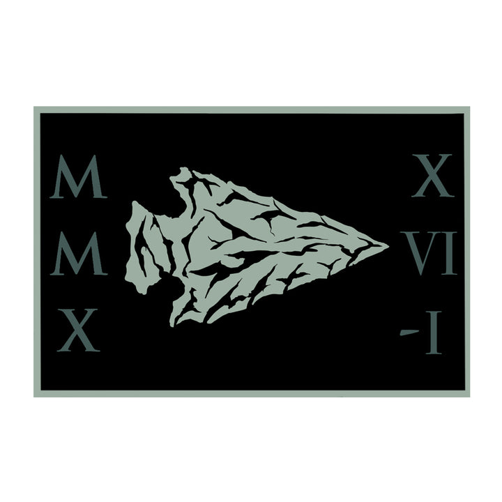 A stylized arrowhead centered on a black rectangle with Roman numerals 