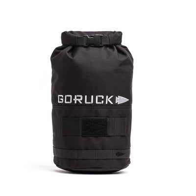 Introducing the Brick Bag (5-50 LBS) by GORUCK: A black rucksack featuring the GORUCK and arrow logo in white. This bag is designed with a roll-top closure, Velcro straps, and a durable exterior. Inspired by military gear, it functions as versatile training equipment or a dependable stuff sack for your adventures.