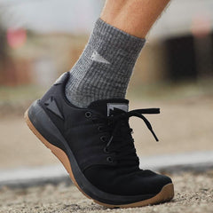 GORUCK black rucking shoe with gum sole worn on foot outdoors, close-up view