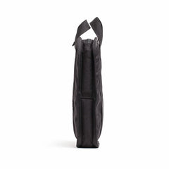 The side view of this sleek, black Sand Ruck Plates by GORUCK features two short handles, highlighting its compact design. Standing upright against a white background, it embodies both elegance and durability, with a lifetime guarantee to match.