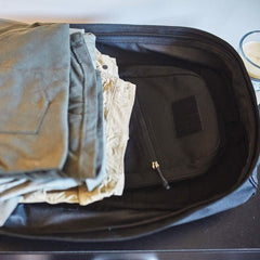 GORUCK rucksack open with folded pants and gear neatly packed inside