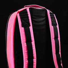 Close-up of GORUCK tough rucking backpack with black back panel and pink padded straps on black background